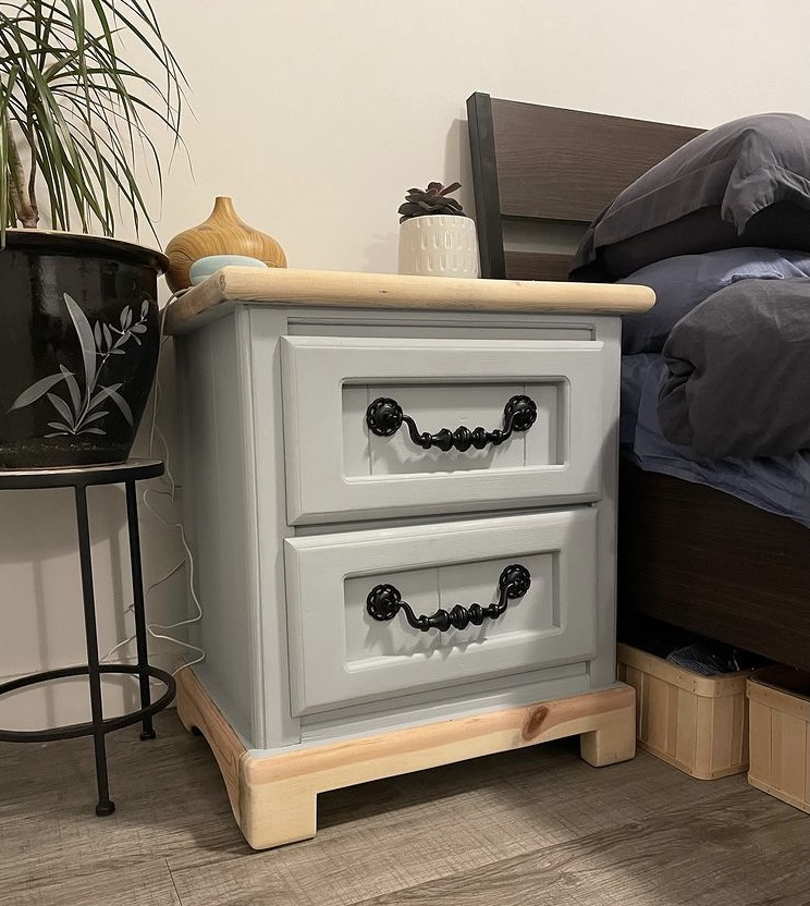 Light blue nightstand with black hardware and light wood accents