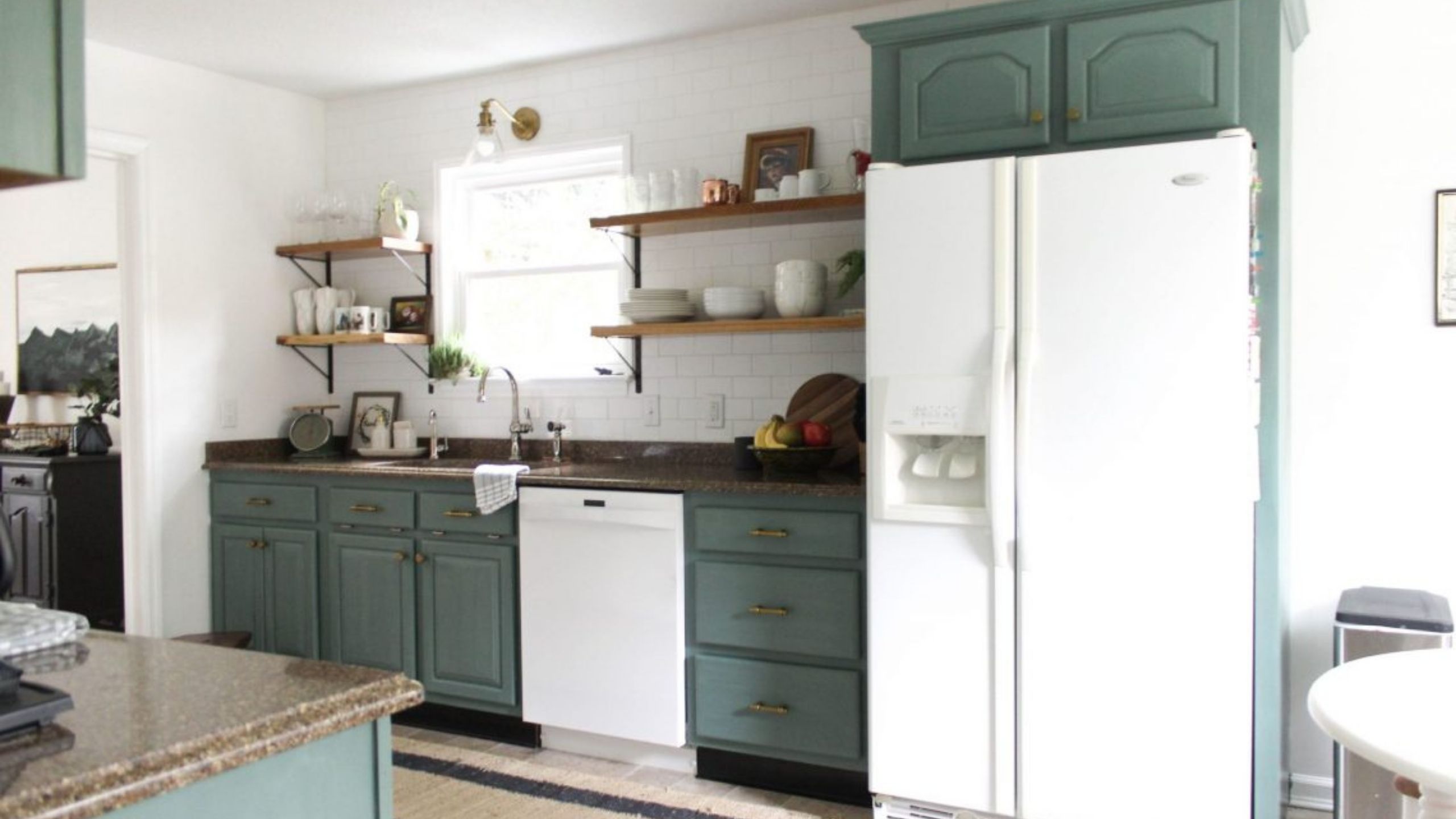 Teal green chalk painted kitchen cabinets with white appliances