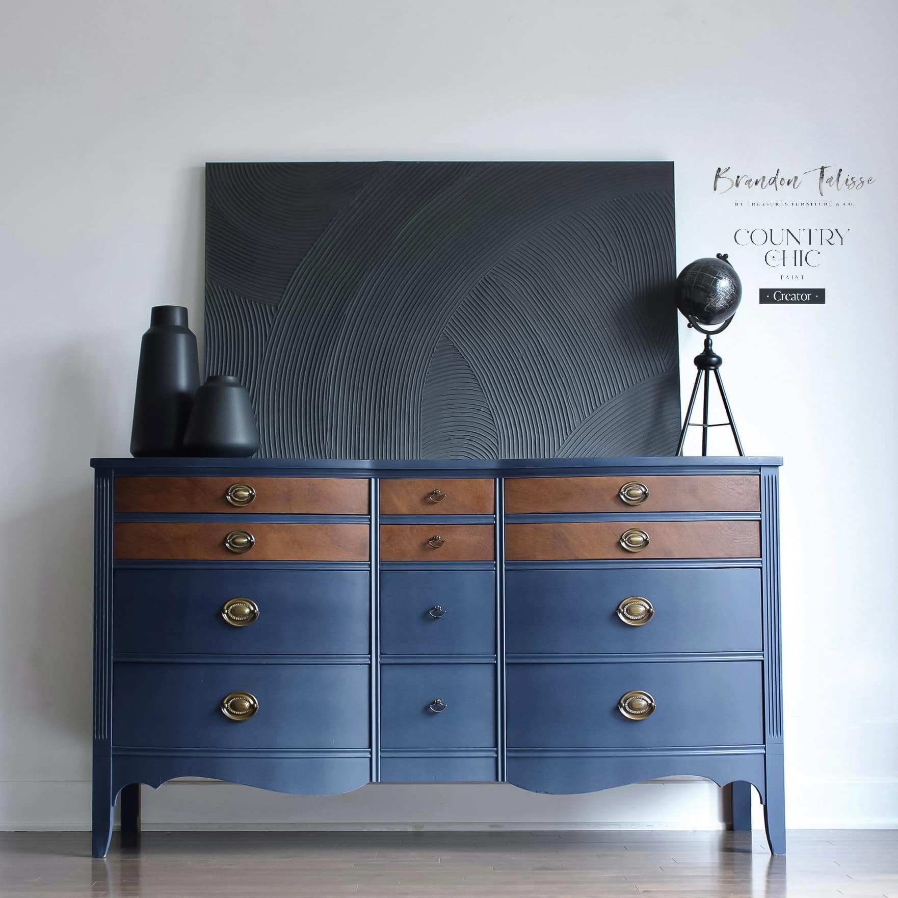 Navy blue painted dresser with stained wood drawer fronts and large black wall art