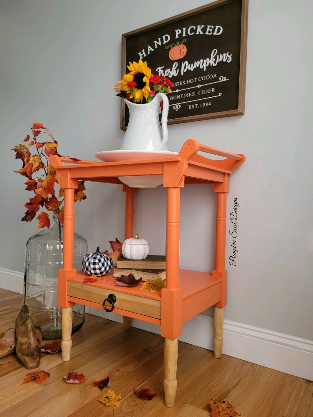 Bright orange painted side table tea cart with autumn florals