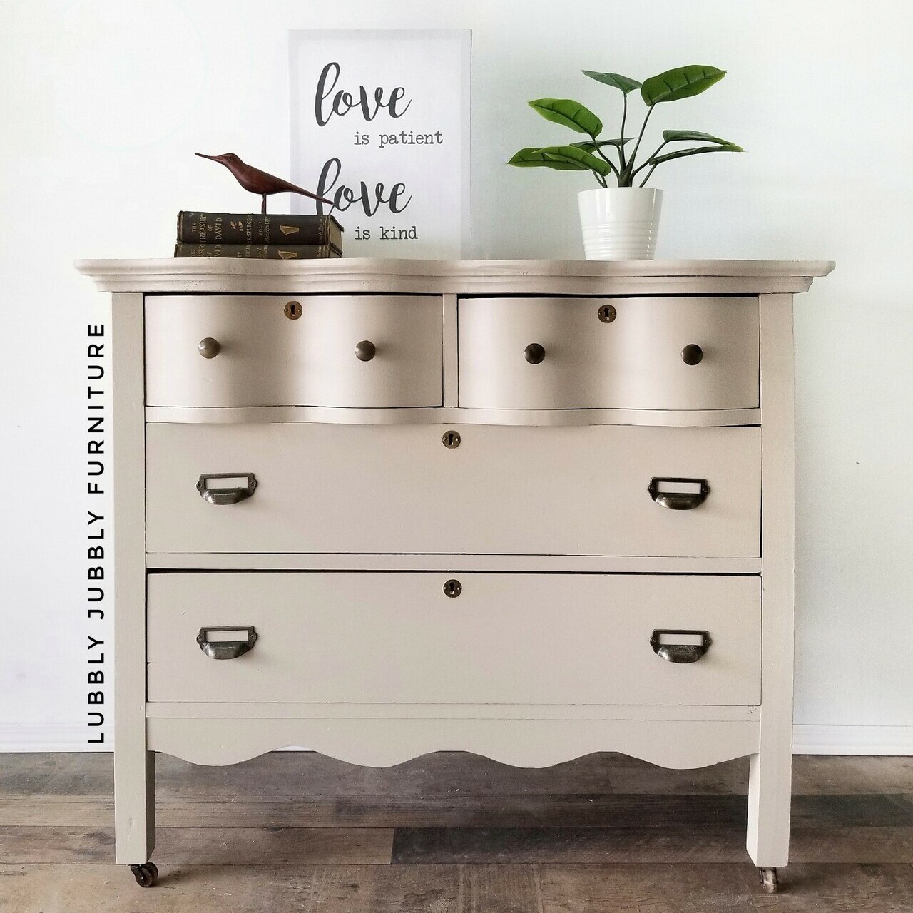 A wooden dresser painted in the Country Chic Paint warm beige color Soiree.