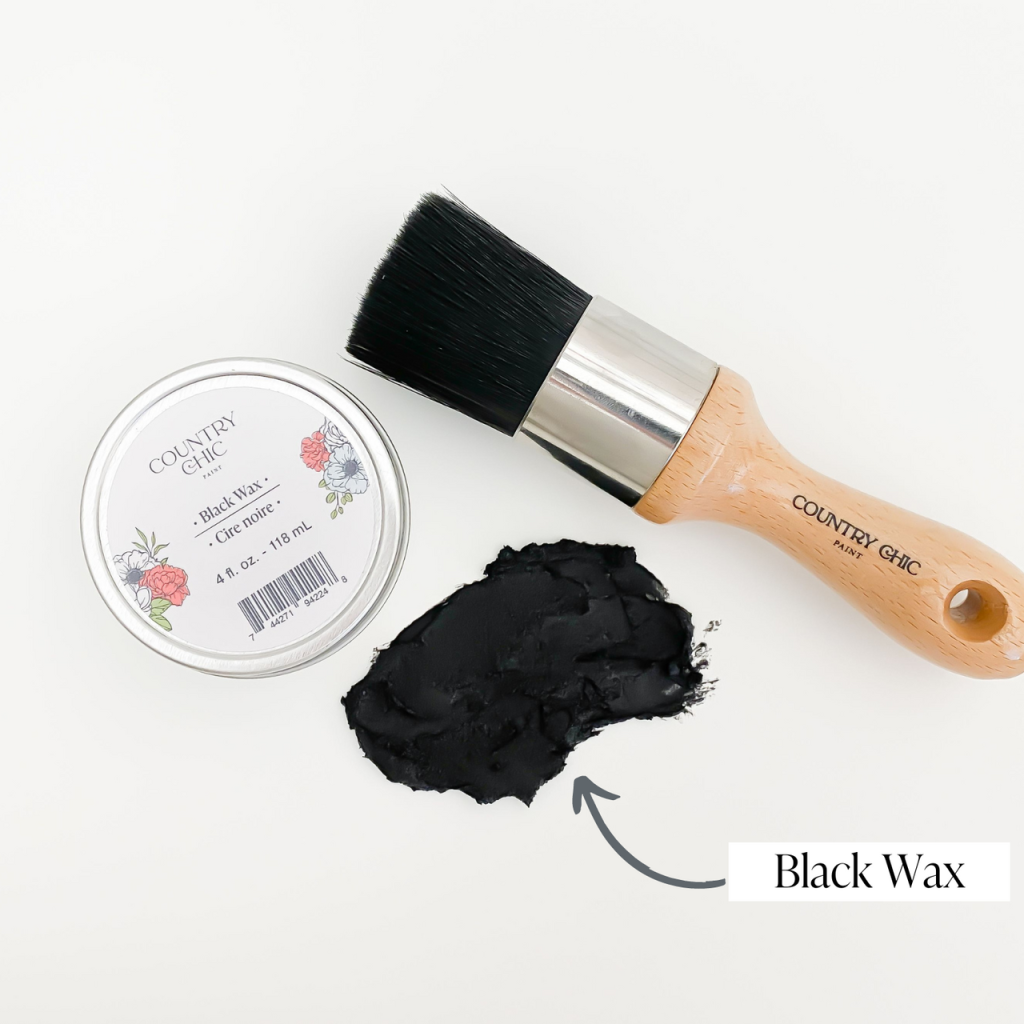 Flatlay of black wax from country chic paint next to wax brush and smear of wax