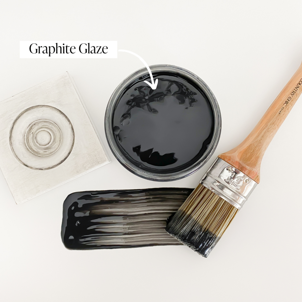 Flatlay jar of graphite black furniture glaze with brush stroke showing color and sample board