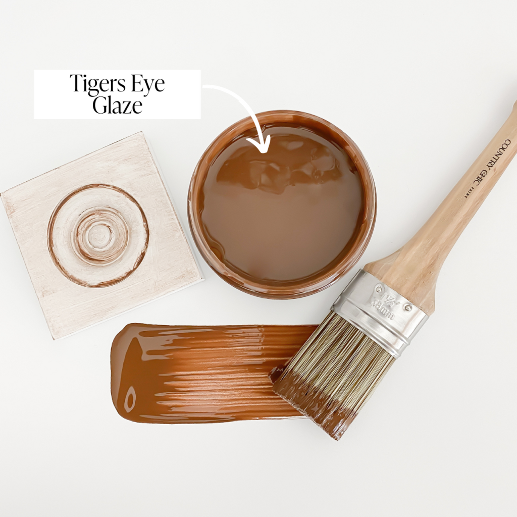 Flatlay jar of tiger's eye warm brown furniture glaze with brush stroke showing color and sample board