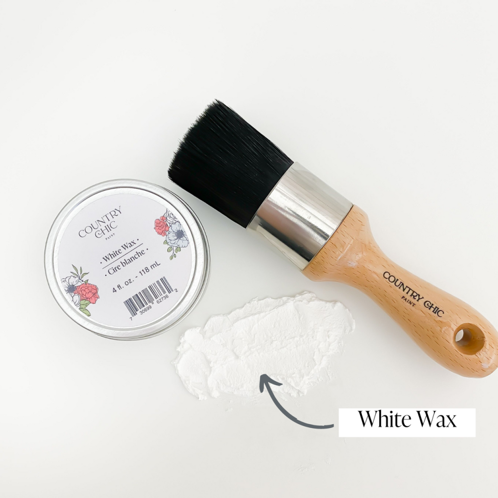 Flatlay of dark white wax from country chic paint next to wax brush and smear of wax